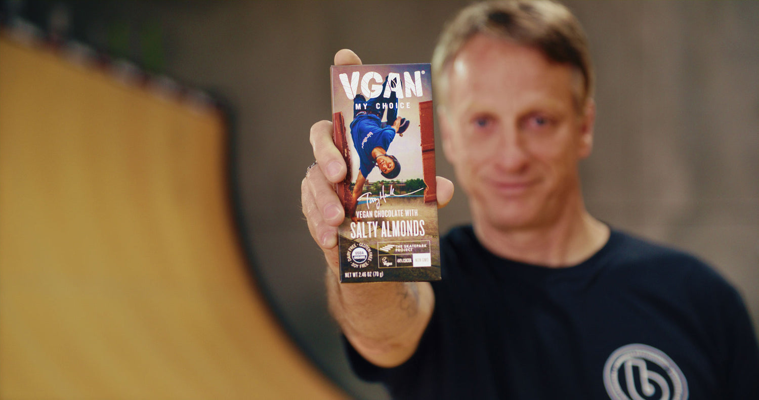 Tony Hawk holding a bar of Vegan Milk Chocolate with Salty Almonds